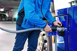 User operating a hydrogen dispenser, a key part of hydrogen infrastructure 