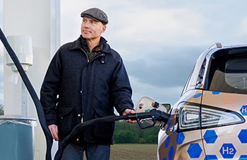 Man refueling a hydrogen vehicle