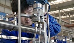 A Shenyang Blower Works employee uses a fluid system built with Swagelok components
